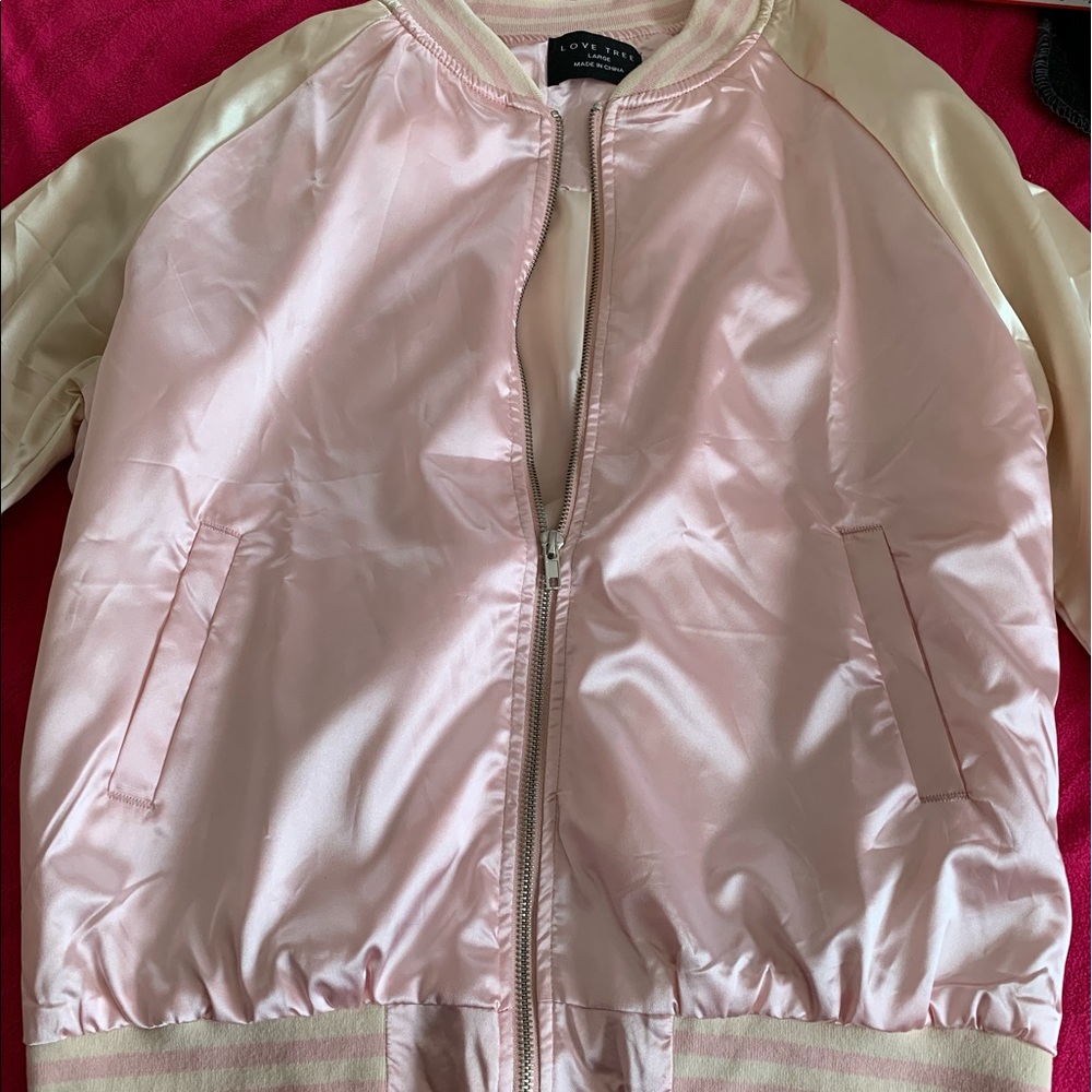 A light pink/cream colored jacket